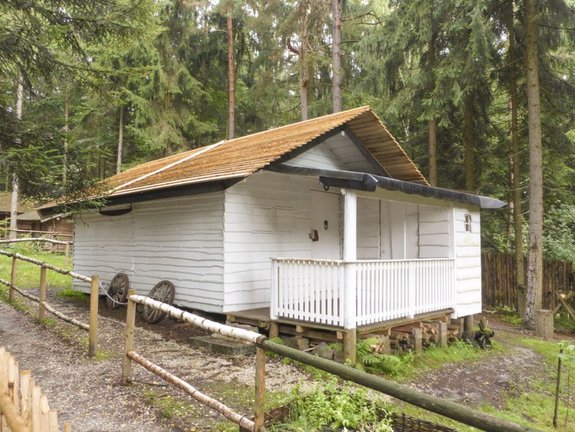 weiß gestrichene Holzhütte im Wald