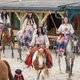 Indianer reiten auf Pferden durch die Westernstadt