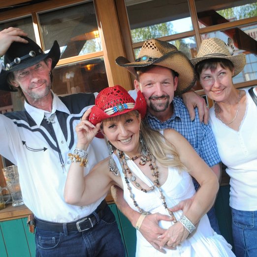 Vier Personen mit Cowboyhüten 