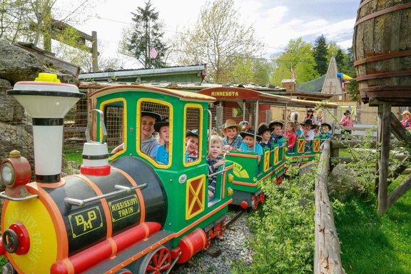 Kinder sitzen in einem kleinen Zug